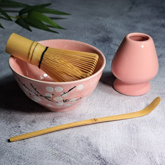 A pink 4-piece set of essential tools to brew your Organic Matcha Tea the Japanese style. 1. One Naoshi (Whisk Holder) 2. One Chawan (Matcha Bowl)  3. One Chasen (Golden Bamboo Whisk) 4. One Chashaku (Golden Bamboo Scoop)