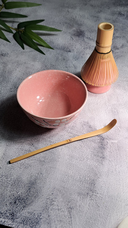 A pink 4-piece set of essential tools to brew your Organic Matcha Tea the Japanese style. 1. One Naoshi (Whisk Holder) 2. One Chawan (Matcha Bowl)  3. One Chasen (Golden Bamboo Whisk) 4. One Chashaku (Golden Bamboo Scoop)